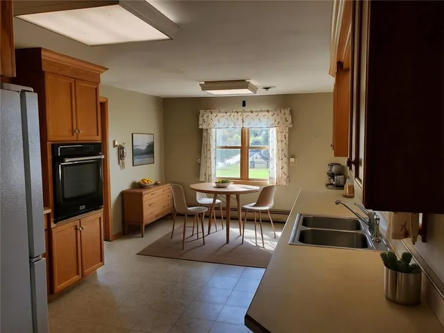 a dining room with furniture and wooden floor