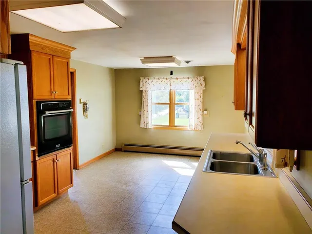 a kitchen with stainless steel appliances a stove top oven