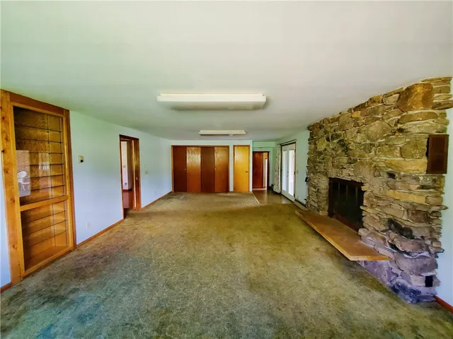 a view of an empty room with a fireplace