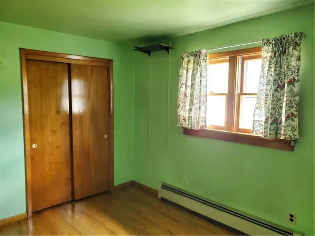 a view of room with window and wooden floor