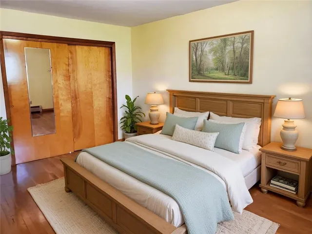 a bedroom with a bed and a painting on the wall