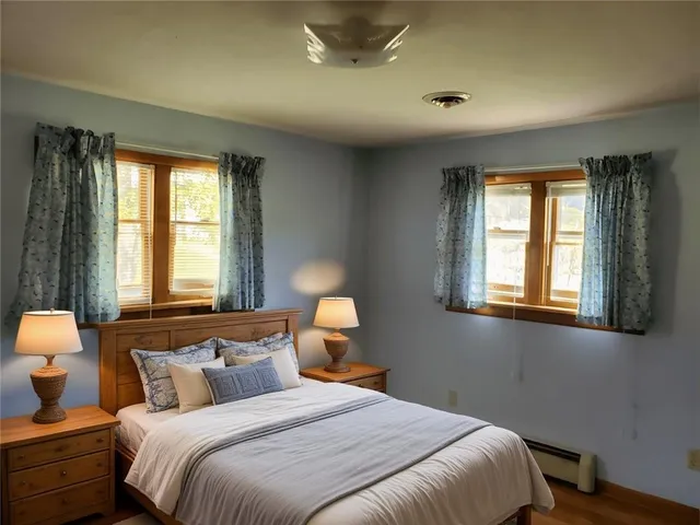 a bedroom with bed and window with lamp