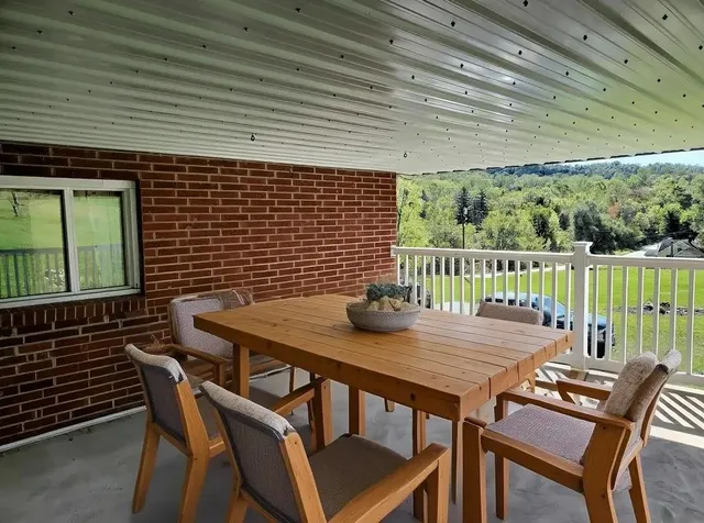 a view of a patio with table and chairs
