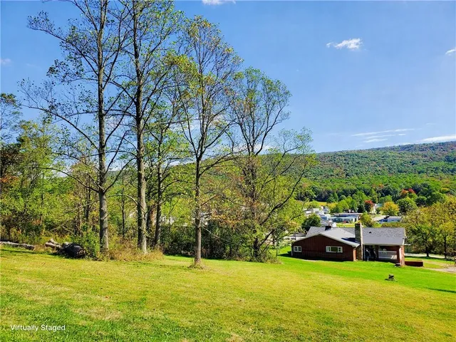 a view of yard with swimming pool and green space