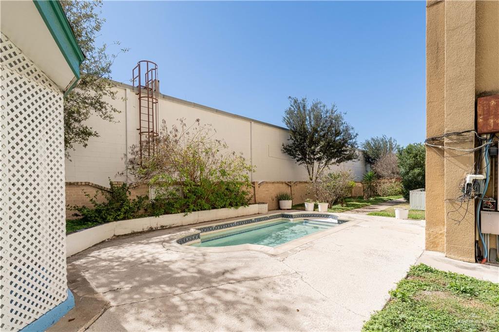 5321 North 10th Street, Unit 102 McAllen, TX 78504 - Photo 4 of 7 a pathway of a house with a yard