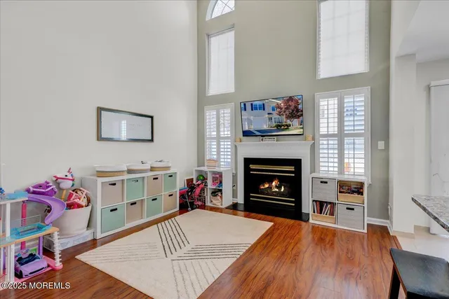 a view of a livingroom with a fireplace and workspace
