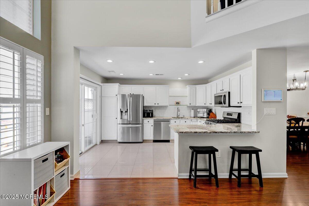 3 Ganton Way Manalapan, NJ 07726 - Photo 14 of 39 a large white kitchen with lots of counter space and stainless steel appliances