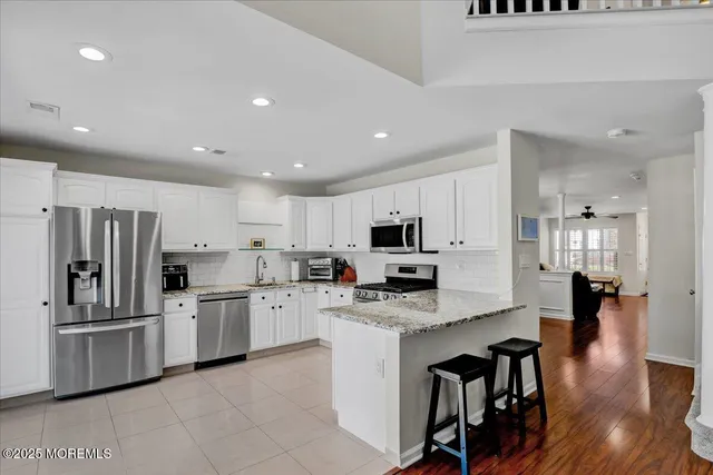 a kitchen with stainless steel appliances a refrigerator sink and cabinets