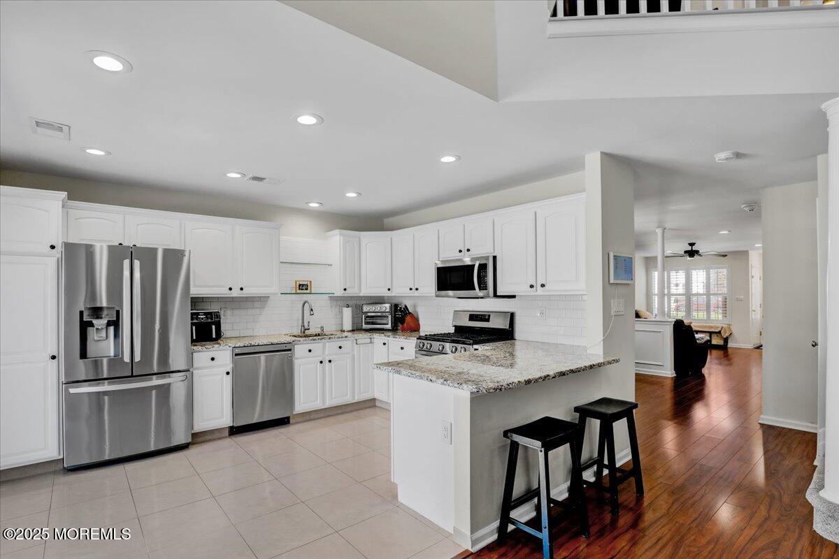 3 Ganton Way Manalapan, NJ 07726 - Photo 15 of 39 a kitchen with stainless steel appliances a refrigerator sink and cabinets