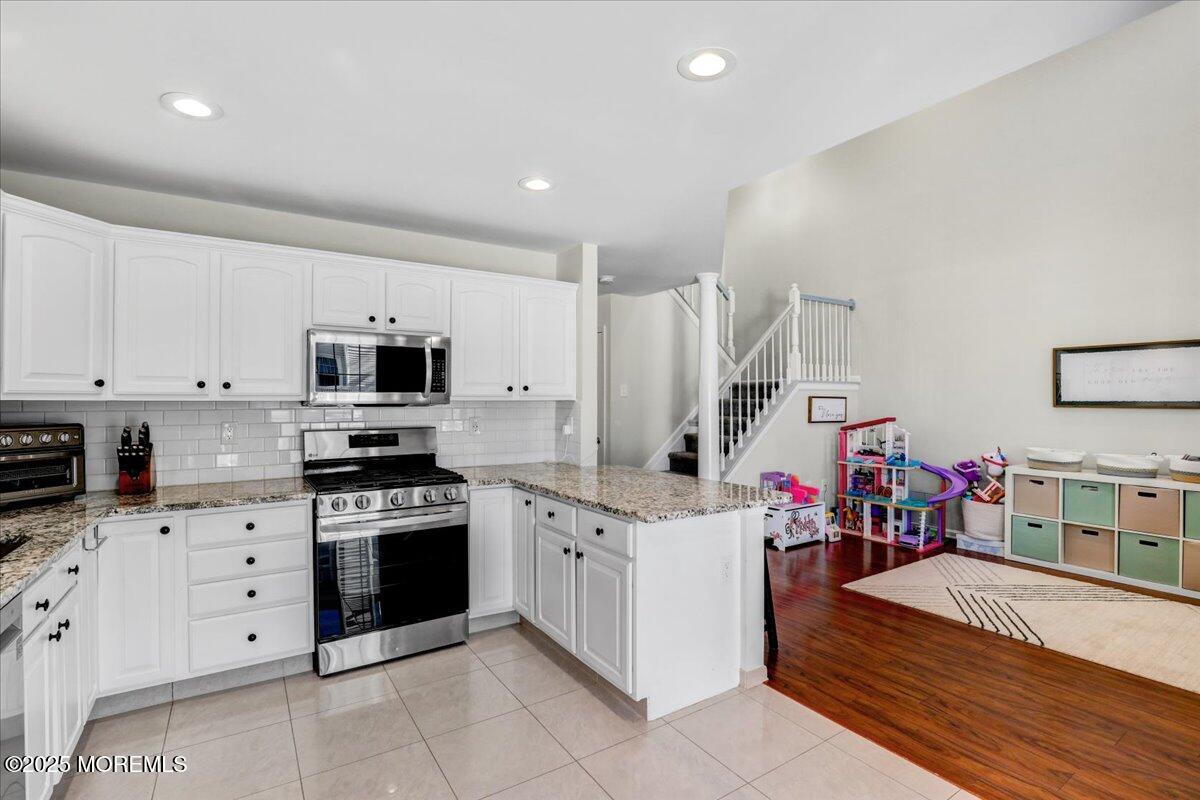 3 Ganton Way Manalapan, NJ 07726 - Photo 16 of 39 a open kitchen with stainless steel appliances granite countertop a stove and cabinets