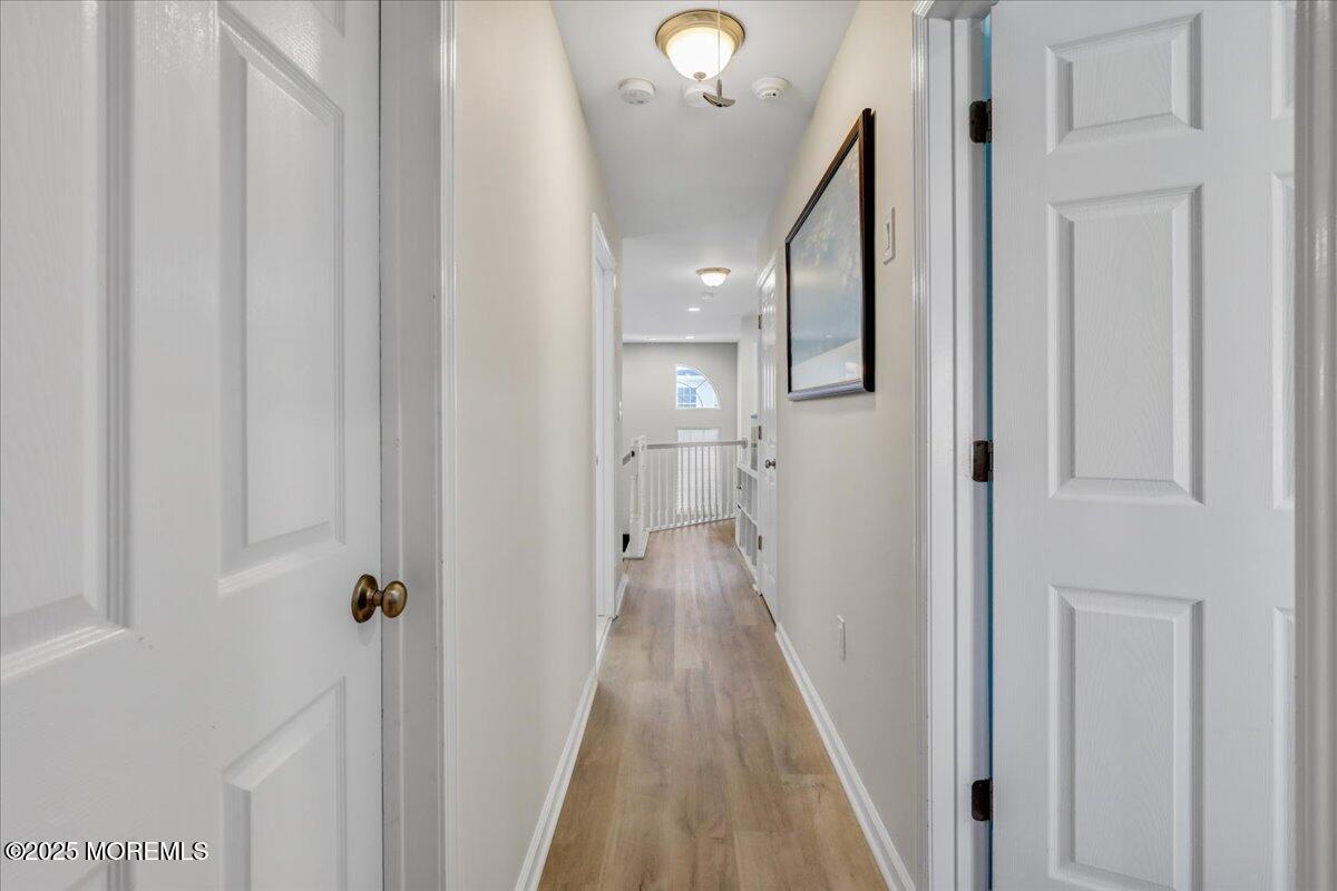 3 Ganton Way Manalapan, NJ 07726 - Photo 18 of 39 a view of a hallway with wooden floor and staircase