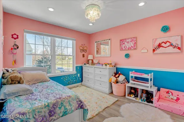 a bedroom with furniture and a window