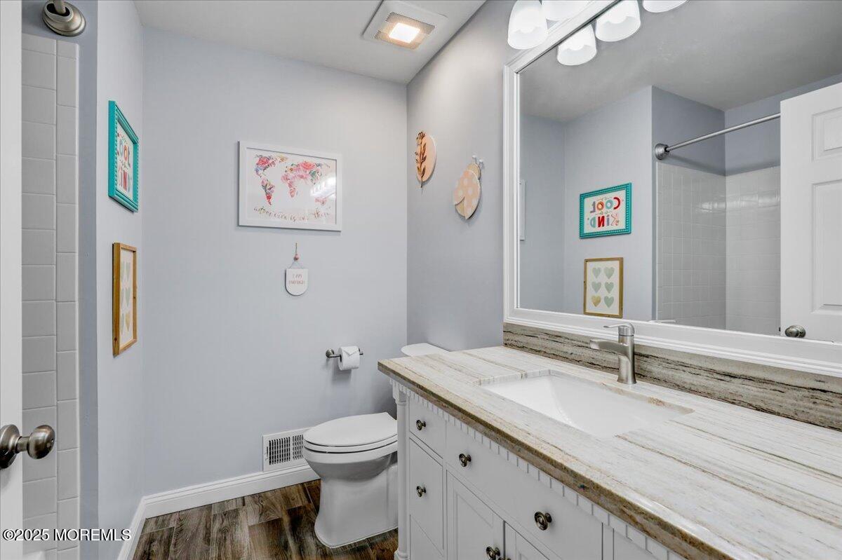 3 Ganton Way Manalapan, NJ 07726 - Photo 25 of 39 a bathroom with a granite countertop sink a toilet and a mirror