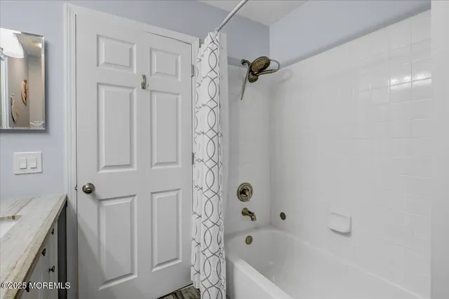 a bathroom with a bathtub a toilet and a shower