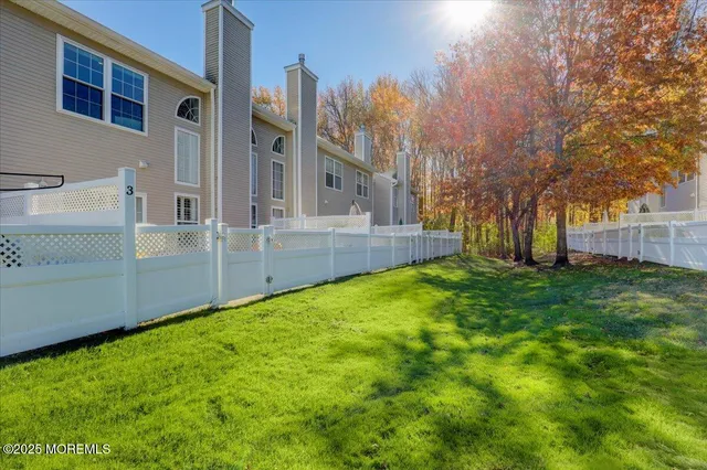 a view of a backyard with large trees