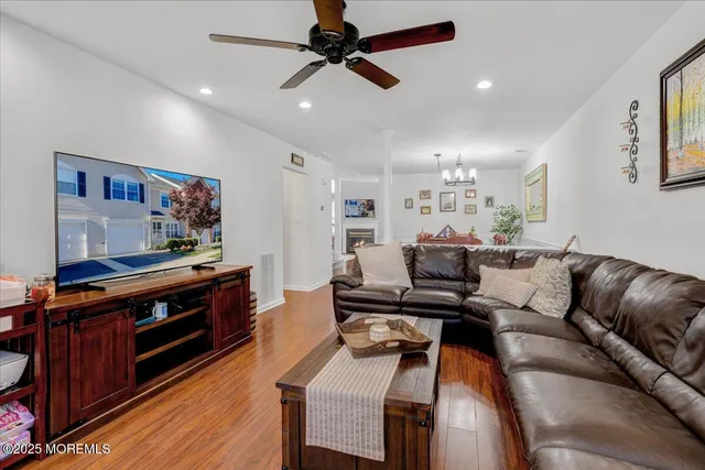 a living room with furniture and a wooden floor