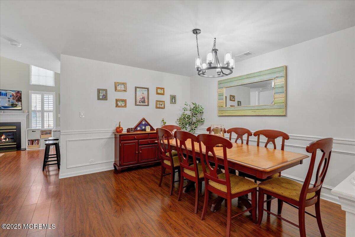 3 Ganton Way Manalapan, NJ 07726 - Photo 9 of 39 a view of a dining room with furniture wooden floor and a chandelier