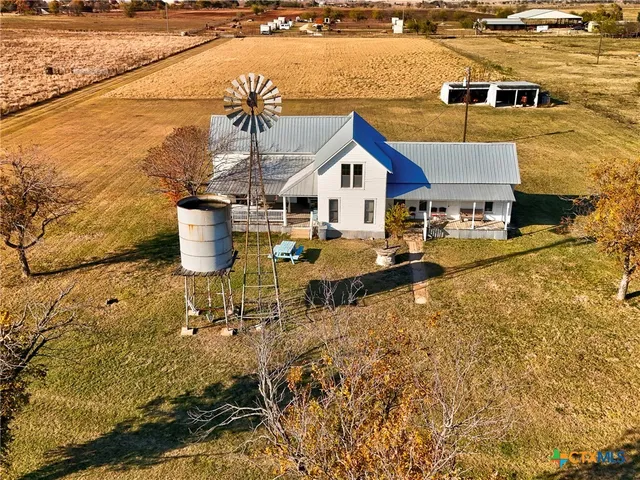 a view of a house with yard and lake view
