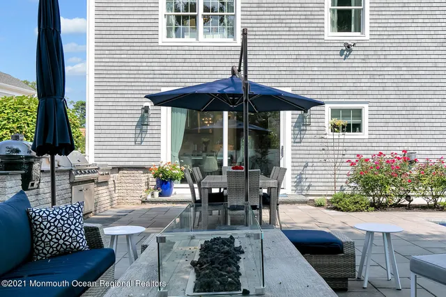 a swimming pool view with a seating space and a garden