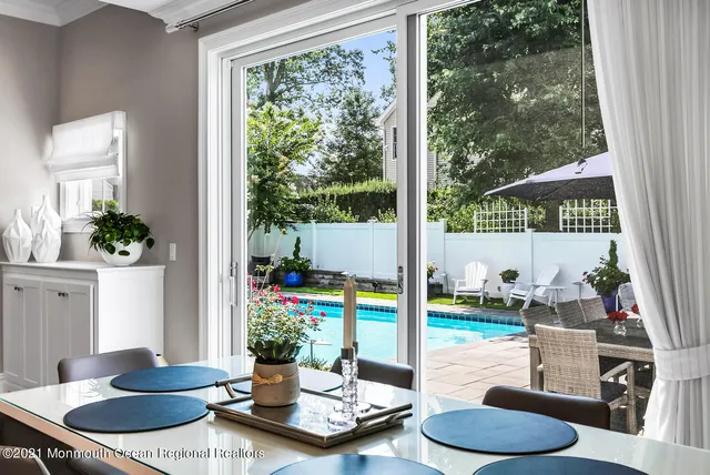a kitchen with granite countertop a stove and a white cabinets