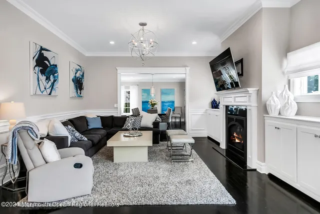 a living room with furniture and a chandelier