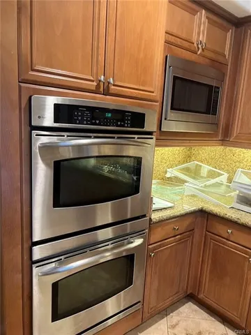 a kitchen with granite countertop a stove microwave and sink