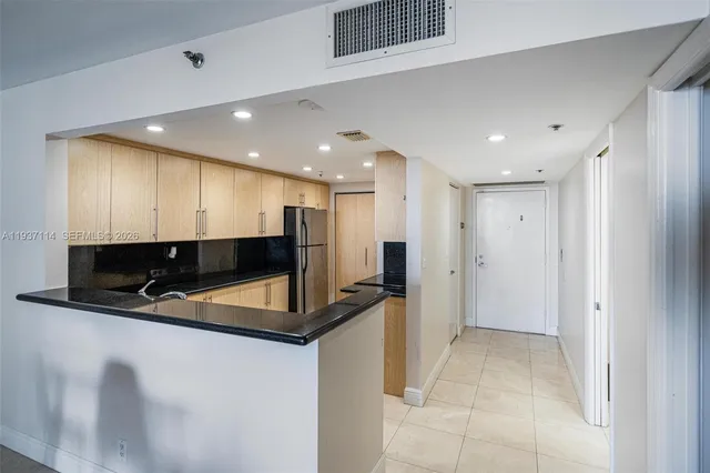 a living room with furniture a flat screen tv and a dining table