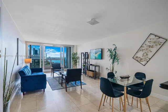 a bedroom with a large bed a flat tv screen and dresser