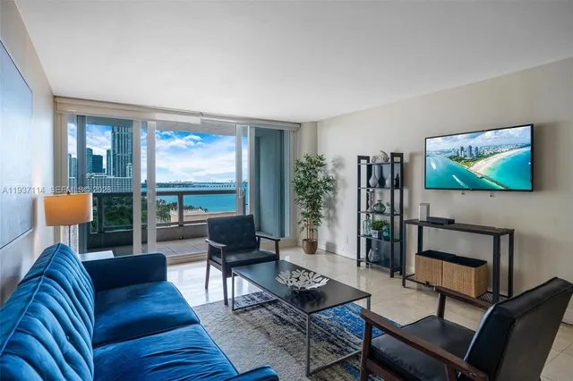 a living room with furniture and a potted plant