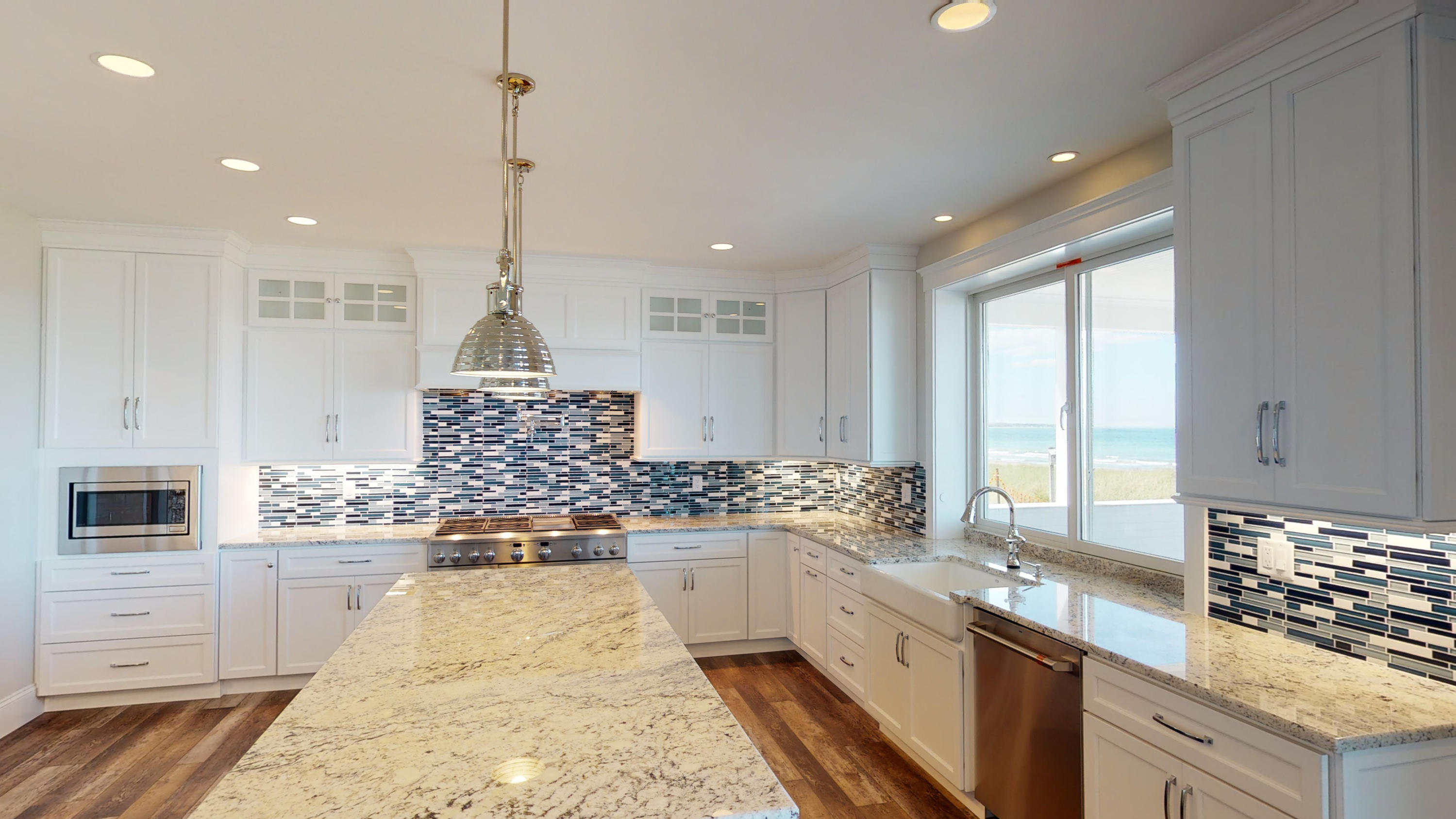 253 Phillips Road Sandwich, MA 02563 - Photo 3 of 28 a large kitchen with kitchen island granite countertop a sink a counter space appliances and cabinets