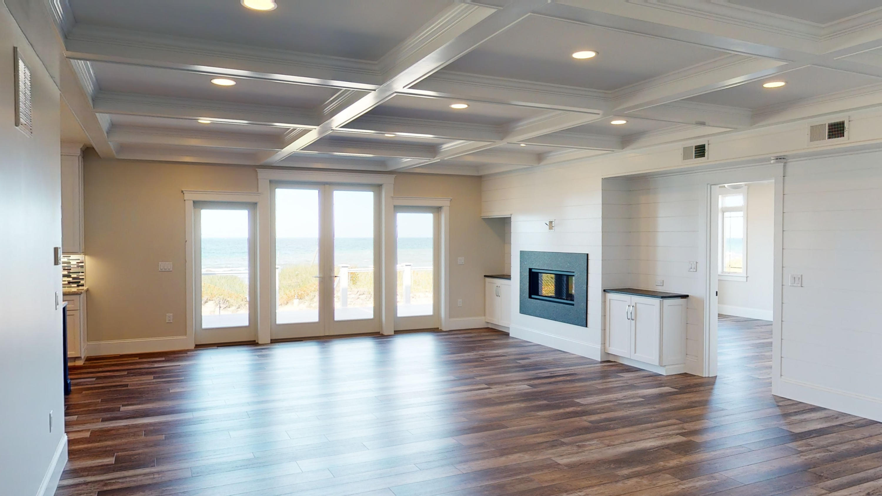 253 Phillips Road Sandwich, MA 02563 - Photo 6 of 28 an empty room with wooden floor and fireplace