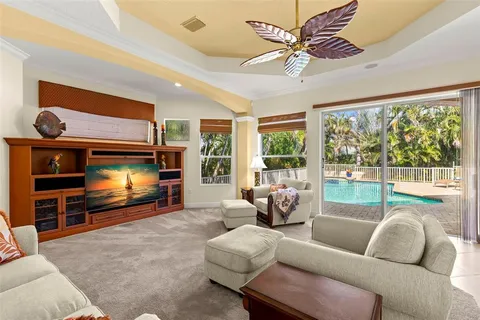a view of a dining room with furniture a chandelier and window