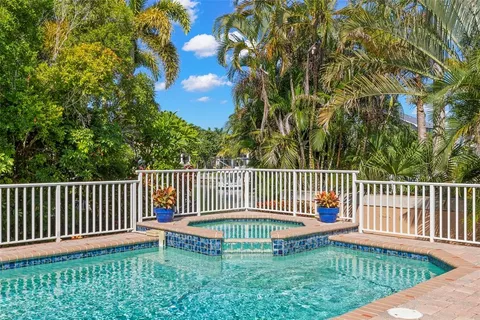 a view of a dining room with furniture and a chandelier