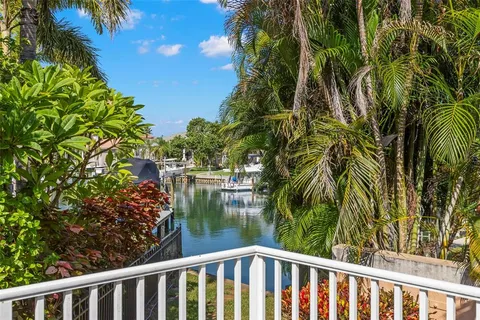 a bedroom with a bed and a chandelier fan