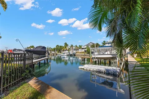 a spacious bedroom with a bed a chandelier and a window