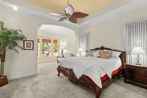 a bedroom with a bed and a ceiling fan