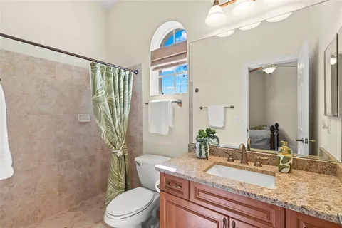 a bedroom with bed and paintings on the wall