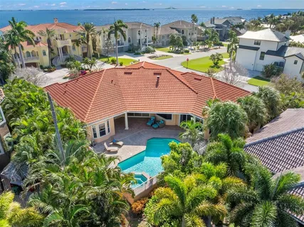 a view of a patio with a table chairs potted plants and wooden fence