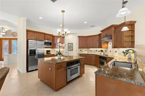 a dining room with furniture and a floor to ceiling window