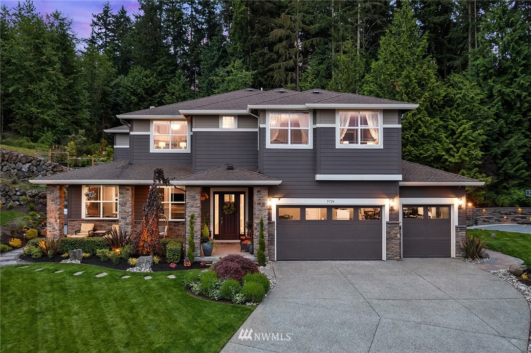 5724 197th Place Southeast Bothell, WA 98012 - Photo 1 of 40 a front view of a house with a garden