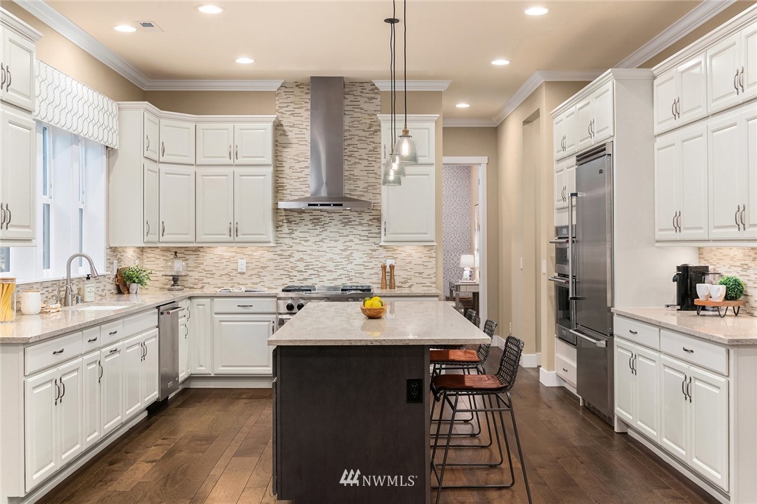 5724 197th Place Southeast Bothell, WA 98012 - Photo 13 of 40 a kitchen with stainless steel appliances granite countertop a sink stove and refrigerator