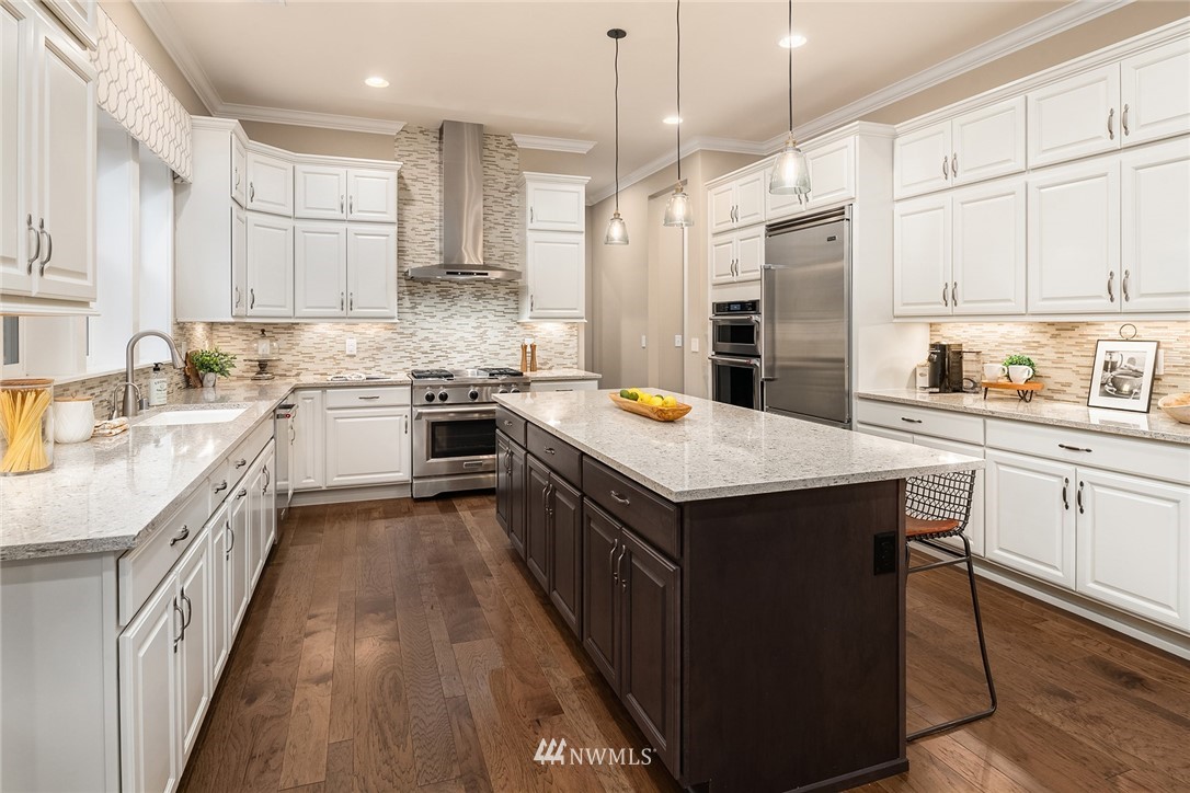 5724 197th Place Southeast Bothell, WA 98012 - Photo 14 of 40 a kitchen with stainless steel appliances granite countertop a sink a stove and a refrigerator