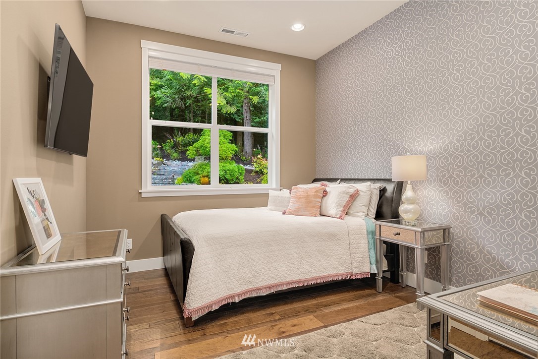 5724 197th Place Southeast Bothell, WA 98012 - Photo 20 of 40 a bedroom with a bed and flat screen tv