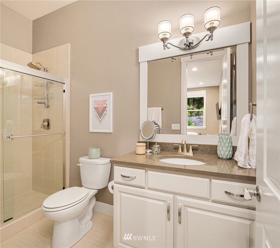 5724 197th Place Southeast Bothell, WA 98012 - Photo 21 of 40 a bathroom with a granite countertop sink a toilet and a mirror