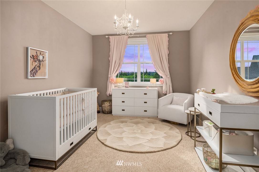 5724 197th Place Southeast Bothell, WA 98012 - Photo 25 of 40 a view of a bedroom with furniture window and a chandelier