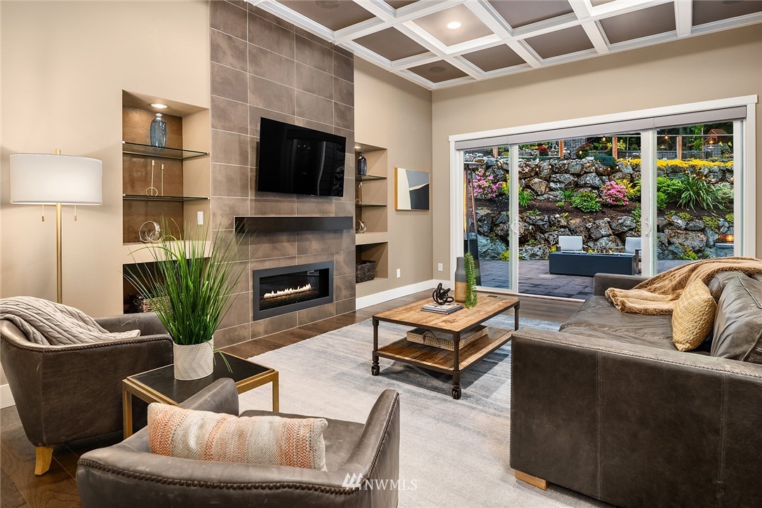 5724 197th Place Southeast Bothell, WA 98012 - Photo 4 of 40 a living room with furniture a fireplace and a flat screen tv