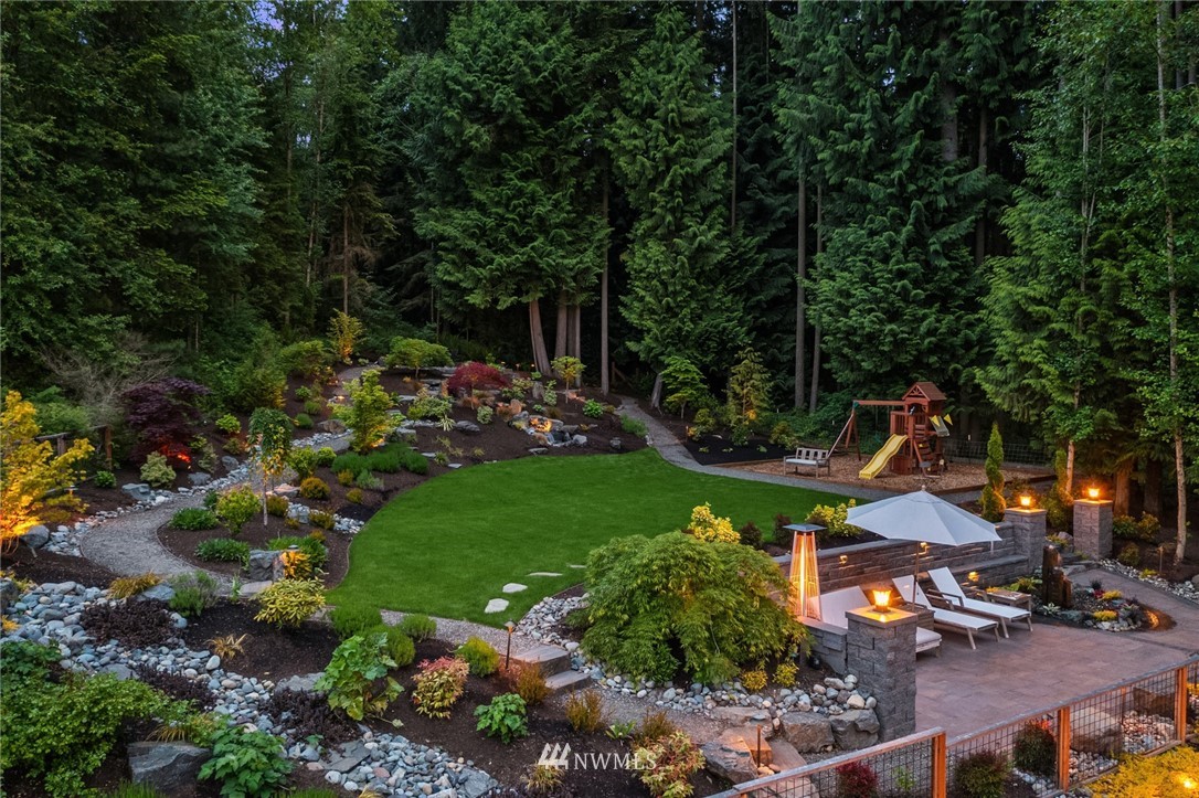 5724 197th Place Southeast Bothell, WA 98012 - Photo 33 of 40 a view of a garden with plants and large trees