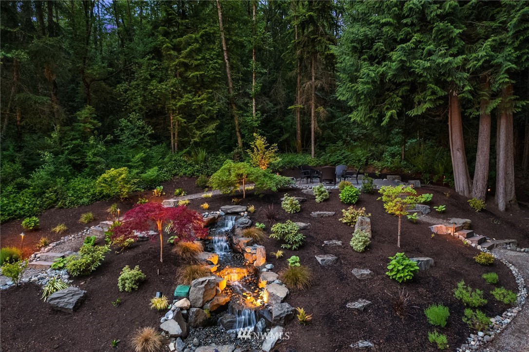 5724 197th Place Southeast Bothell, WA 98012 - Photo 37 of 40 a view of a garden with plants and large trees