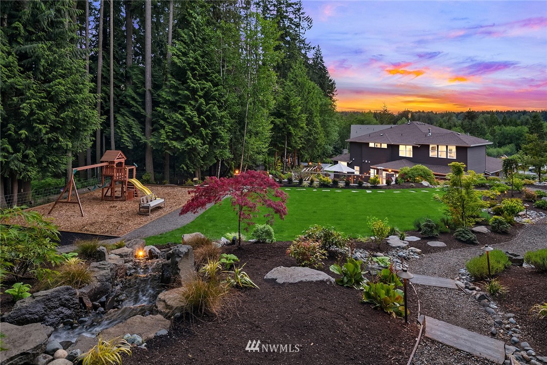 5724 197th Place Southeast Bothell, WA 98012 - Photo 38 of 40 a view of a patio with a table and chairs under an umbrella