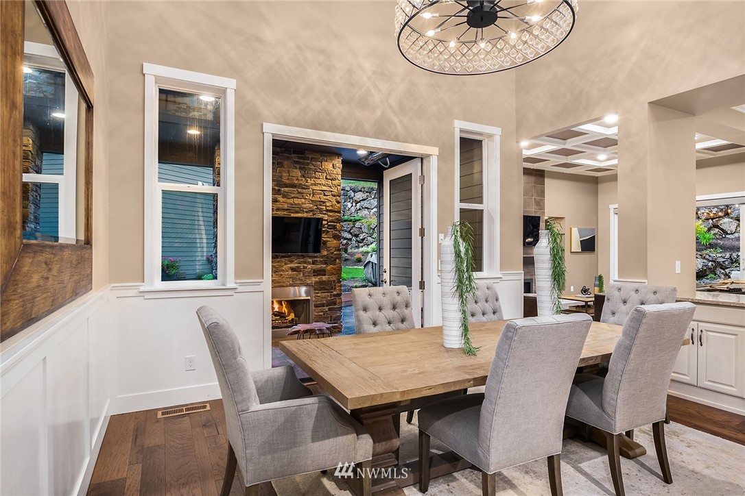 5724 197th Place Southeast Bothell, WA 98012 - Photo 10 of 40 a view of a dining room with furniture window and wooden floor